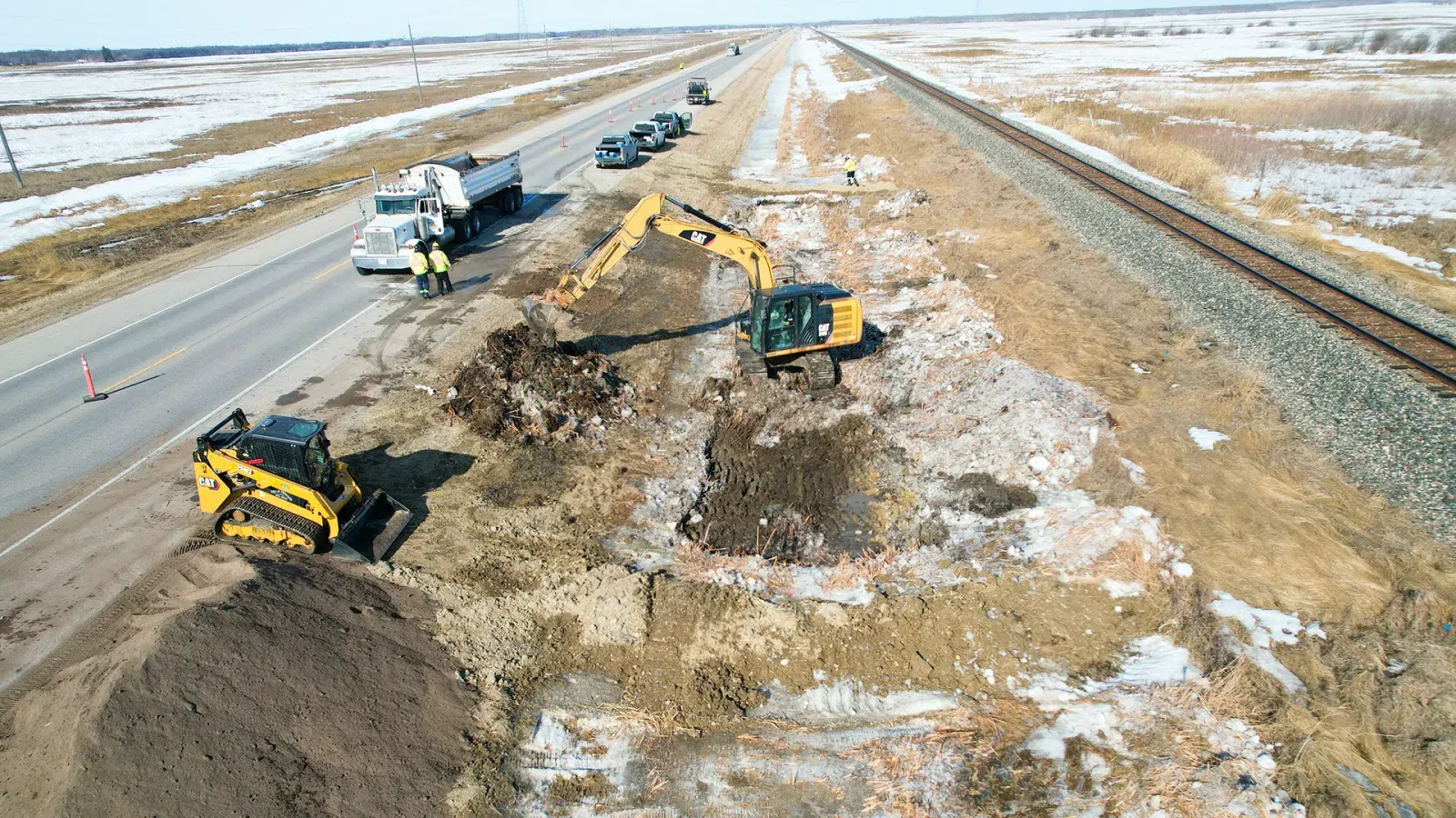 Remediation of a diesel spill. A Miller Environmental excavator removes diesel contaminated soil at the side of Manitoba Highway 16.
